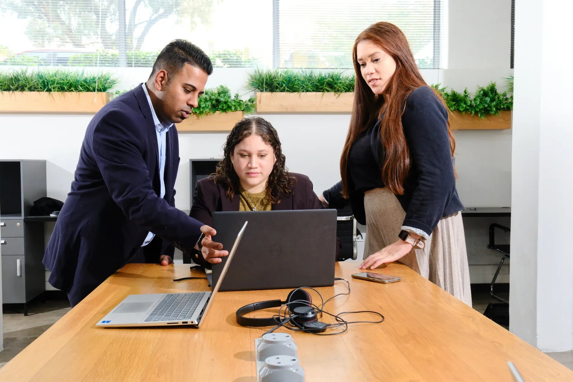 Group of people sat round laptop